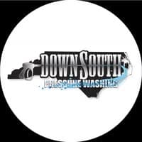 Down South Pressure Washing logo: a white circular badge with a black North Carolina state silhouette, the Down South wordmark and a blue water arc spraying across it.